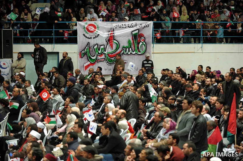 Tunisian Islamist Ennahdha Party supporters cheer as they greet of Palestinian Prime Minister in gaza strip, Ismail Haniya on January 7, 2012 in Tunis. Photo by Mohammed Al-Ostaz