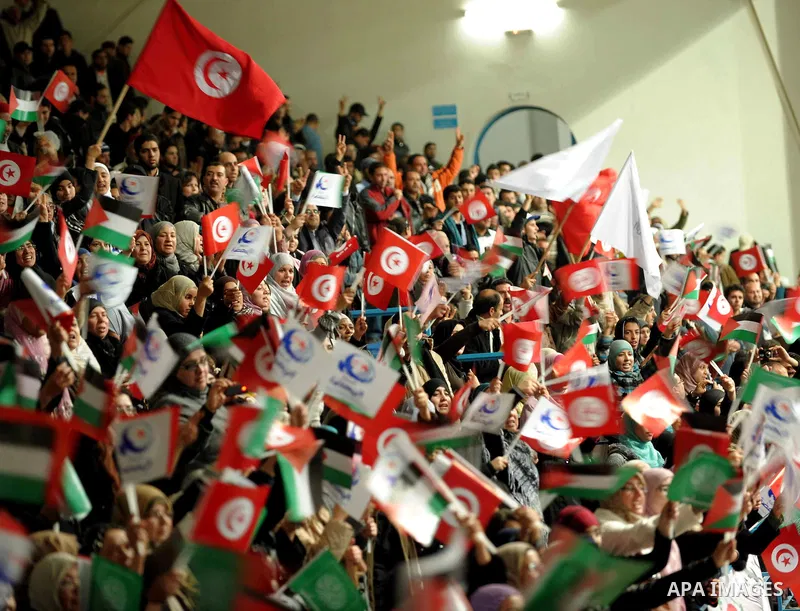 Tunisian Islamist Ennahdha Party supporters cheer as they greet of Palestinian Prime Minister in gaza strip, Ismail Haniya on January 7, 2012 in Tunis. Photo by Mohammed Al-Ostaz
