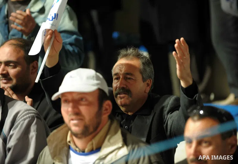 Tunisian Islamist Ennahdha Party supporters cheer as they greet of Palestinian Prime Minister in gaza strip, Ismail Haniya on January 7, 2012 in Tunis. Photo by Mohammed Al-Ostaz