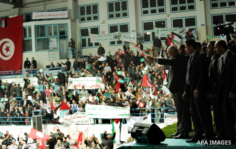 Tunisian Islamist Ennahdha Party supporters cheer as they greet of Palestinian Prime Minister in gaza strip, Ismail Haniya on January 7, 2012 in Tunis. Photo by Mohammed Al-Ostaz