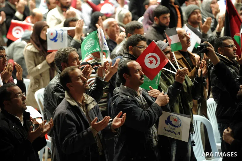 Tunisian Islamist Ennahdha Party supporters cheer as they greet of Palestinian Prime Minister in gaza strip, Ismail Haniya on January 7, 2012 in Tunis. Photo by Mohammed Al-Ostaz