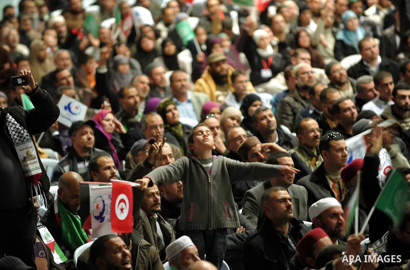 Tunisian Islamist Ennahdha Party supporters cheer as they greet of Palestinian Prime Minister in gaza strip, Ismail Haniya on January 7, 2012 in Tunis. Photo by Mohammed Al-Ostaz