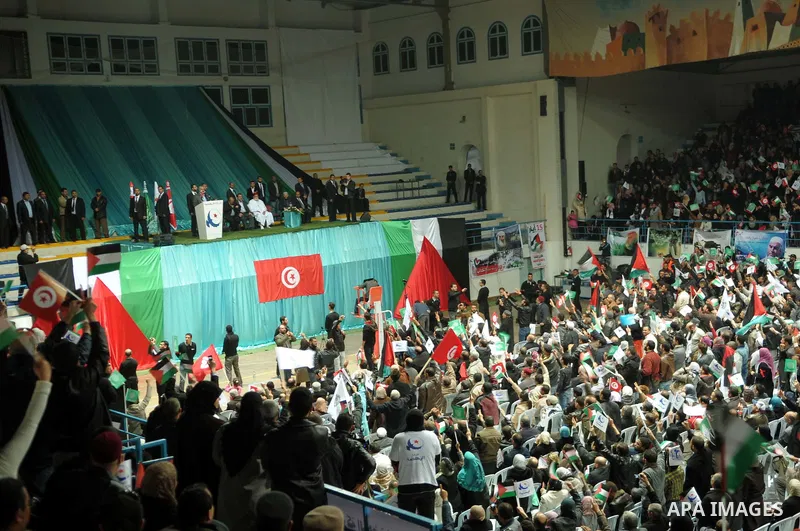 Tunisian Islamist Ennahdha Party supporters cheer as they greet of Palestinian Prime Minister in gaza strip, Ismail Haniya on January 7, 2012 in Tunis. Photo by Mohammed Al-Ostaz