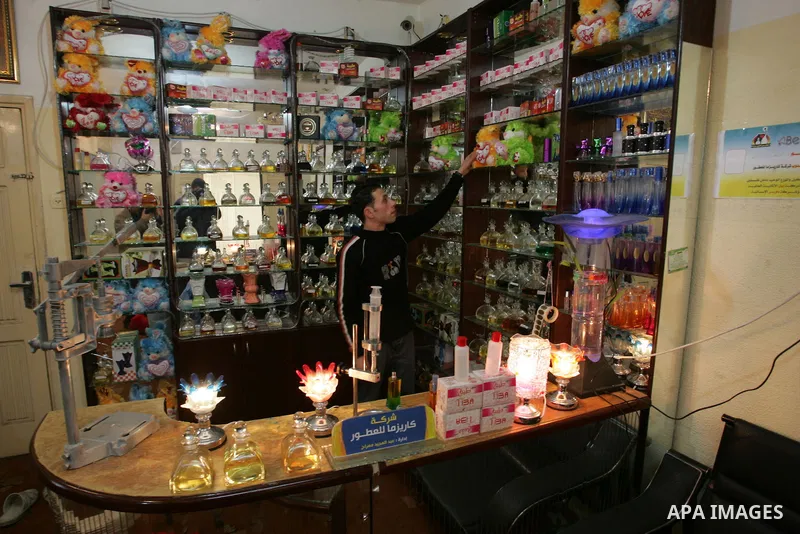A Palestinian man corks a perfume bottle manufactured and sold locally in the Rafah refugee camp in the southern Gaza Strip on January 8, 2012. A report released in October 2011 by the World Bank, reveals a precarious ec...