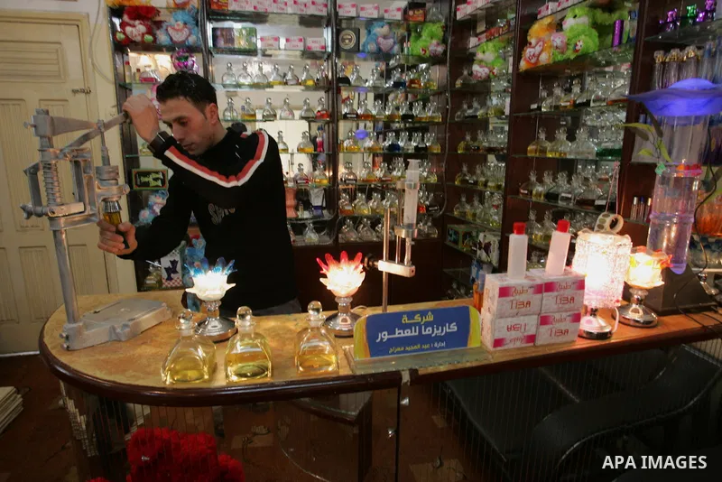 A Palestinian man corks a perfume bottle manufactured and sold locally in the Rafah refugee camp in the southern Gaza Strip on January 8, 2012. A report released in October 2011 by the World Bank, reveals a precarious ec...