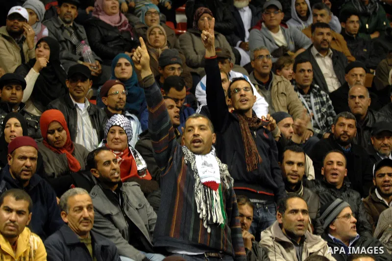 Supporters of the Tunisian islamist Ennahdha Party shout slogans and wave Palestinian flags during a speech delivered by Ismail Haniya, prime minister in the Hamas-ruled Gaza Strip, on January 8, 2012 in Tunis. A visit b...