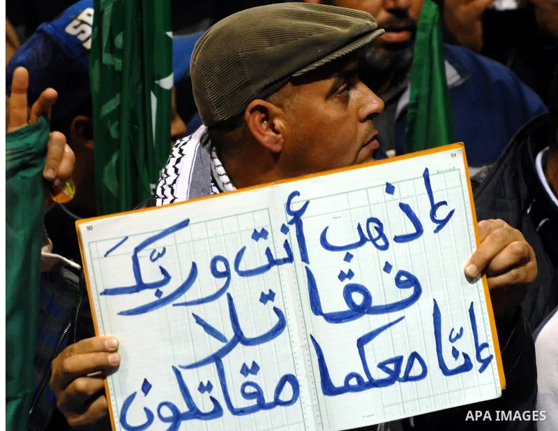 Supporters of the Tunisian islamist Ennahdha Party shout slogans and wave Palestinian flags during a speech delivered by Ismail Haniya, prime minister in the Hamas-ruled Gaza Strip, on January 8, 2012 in Tunis. A visit b...