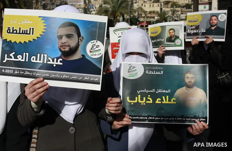 Palestinian Hamas supporters hold up pictures of relatives who were arrested and imprisoned for political reasons by Palestinian Authority security forces, during a protest in the West Bank city of Nablus, on Jan. 09, 20...
