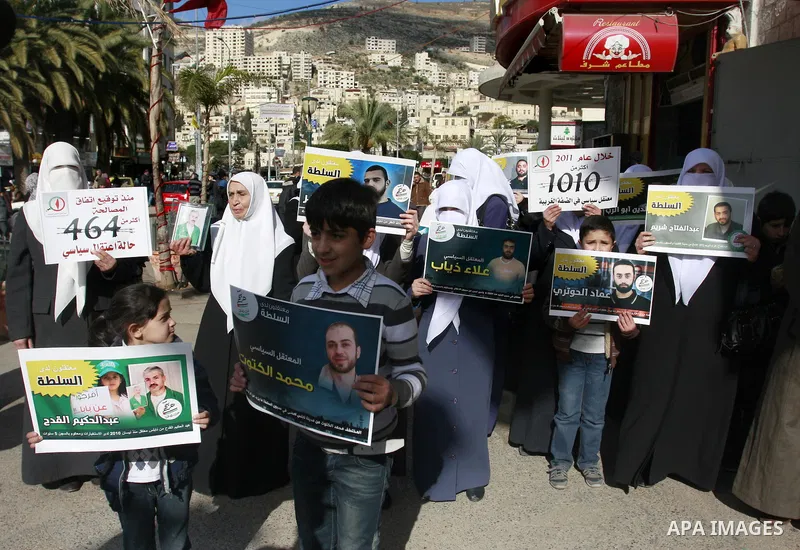 Palestinian Hamas supporters hold up pictures of relatives who were arrested and imprisoned for political reasons by Palestinian Authority security forces, during a protest in the West Bank city of Nablus, on Jan. 09, 20...