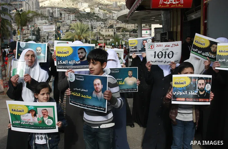 Palestinian Hamas supporters hold up pictures of relatives who were arrested and imprisoned for political reasons by Palestinian Authority security forces, during a protest in the West Bank city of Nablus, on Jan. 09, 20...