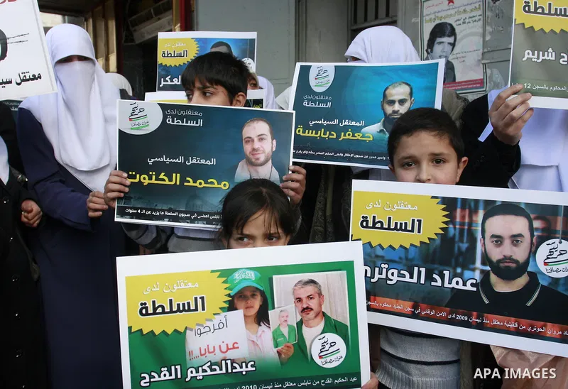 Palestinian Hamas supporters hold up pictures of relatives who were arrested and imprisoned for political reasons by Palestinian Authority security forces, during a protest in the West Bank city of Nablus, on Jan. 09, 20...