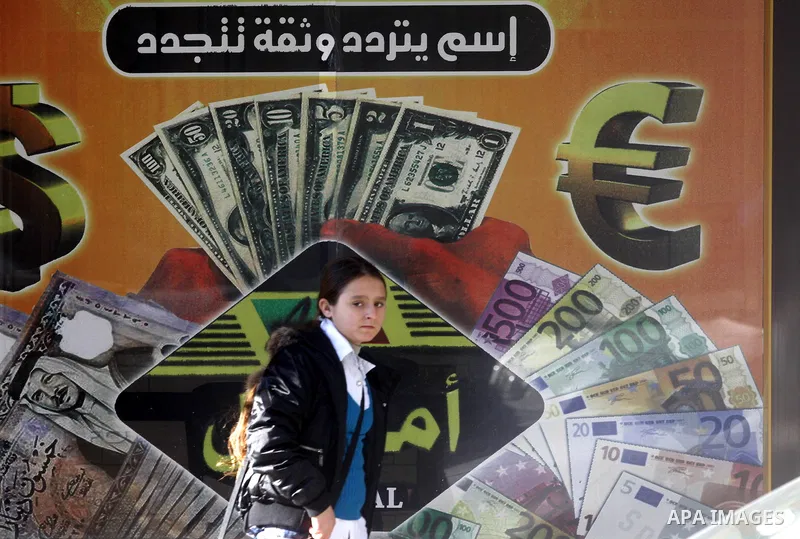A Palestinian walks past a Western Union office in Gaza City Jan. 9, 2011. The Western Union, a global leader in money tranfer services based in the United States, decided on Tuesday to stop dealing with private offices...