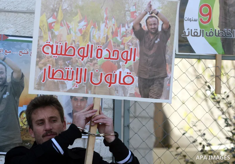 Palestinians hold up pictures of relatives held in Israeli jails during a protest calling for their release, in the West Bank city of Ramallah, on Jan. 10, 2012. Israel currently holds about 6600 Palestinians in its pris...