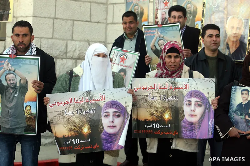 Palestinians hold up pictures of relatives held in Israeli jails during a protest calling for their release, in the West Bank city of Ramallah, on Jan. 10, 2012. Israel currently holds about 6600 Palestinians in its pris...