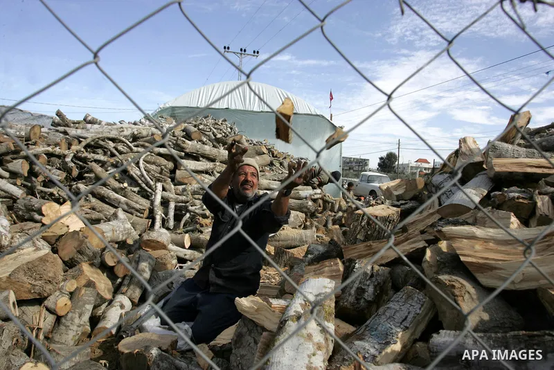 A Palestinian workers collect firewood at a yard in Khan Younis, southern Gaza Strip on January 11, 2012.Photo by Abed Rahim Khatib