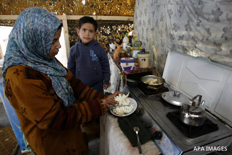 Palestinian family of five persons lives below the poverty line in a refugee camp of Khan Younis in southern Gaza Strip on January 16, 2012. By the third anniversary of the war on Gaza, the agency of the United Nations R...