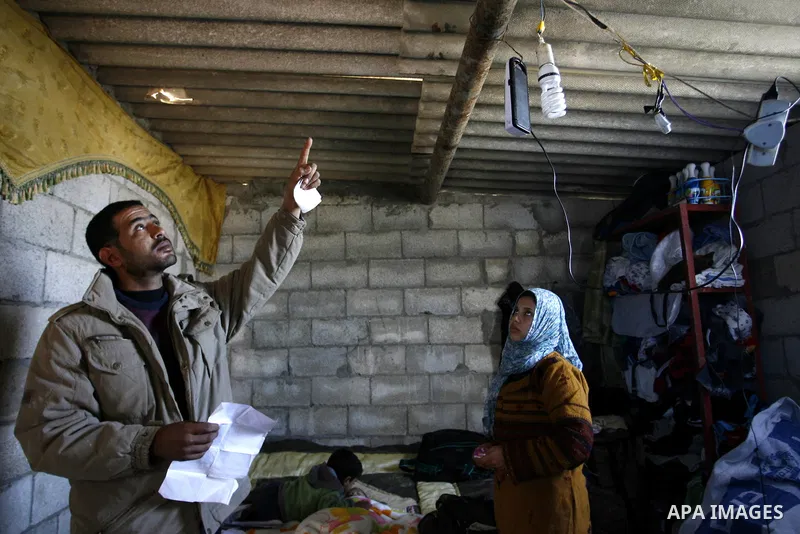 Palestinian family of five persons lives below the poverty line in a refugee camp of Khan Younis in southern Gaza Strip on January 16, 2012. By the third anniversary of the war on Gaza, the agency of the United Nations R...