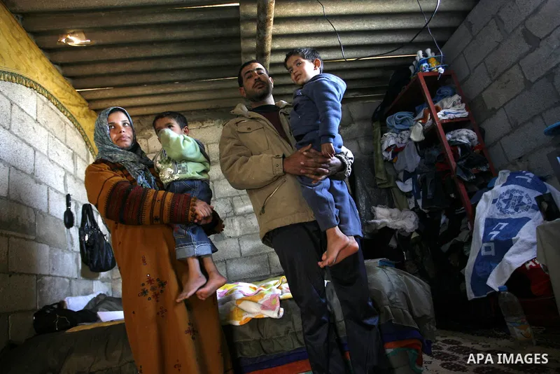 Palestinian family of five persons lives below the poverty line in a refugee camp of Khan Younis in southern Gaza Strip on January 16, 2012. By the third anniversary of the war on Gaza, the agency of the United Nations R...