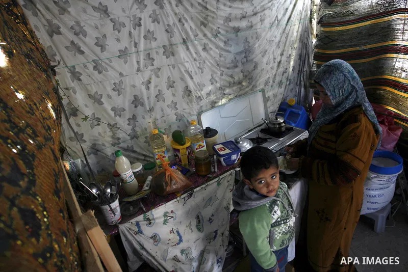 Palestinian family of five persons lives below the poverty line in a refugee camp of Khan Younis in southern Gaza Strip on January 16, 2012. By the third anniversary of the war on Gaza, the agency of the United Nations R...