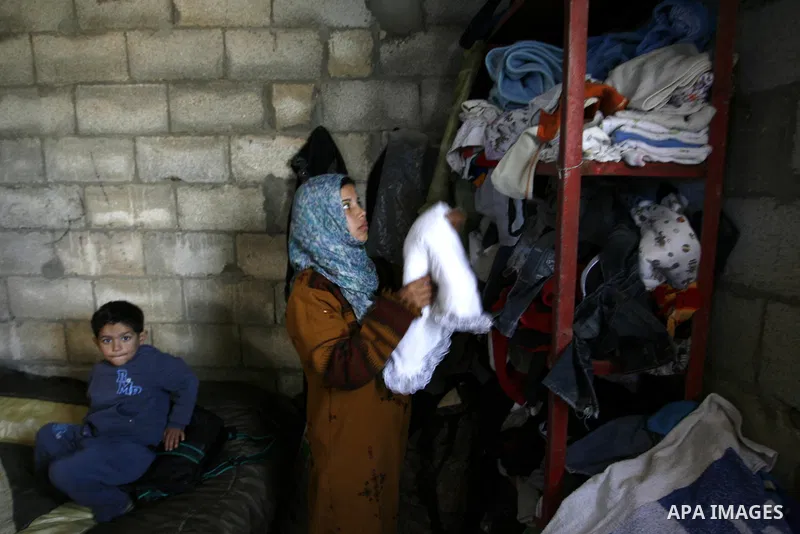 Palestinian family of five persons lives below the poverty line in a refugee camp of Khan Younis in southern Gaza Strip on January 16, 2012. By the third anniversary of the war on Gaza, the agency of the United Nations R...