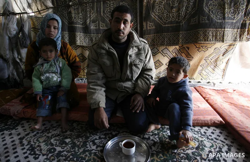 Palestinian family of five persons lives below the poverty line in a refugee camp of Khan Younis in southern Gaza Strip on January 16, 2012. By the third anniversary of the war on Gaza, the agency of the United Nations R...