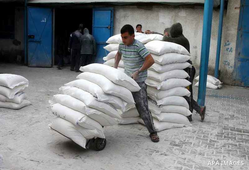 Palestinians receive their monthly food aid at a UN distribution center in the Shati refugee camp, in Gaza City, on January 17, 2012. The UN Agency for Palestinian Refugees (UNRWA) in Gaza launched an appeal for emergenc...