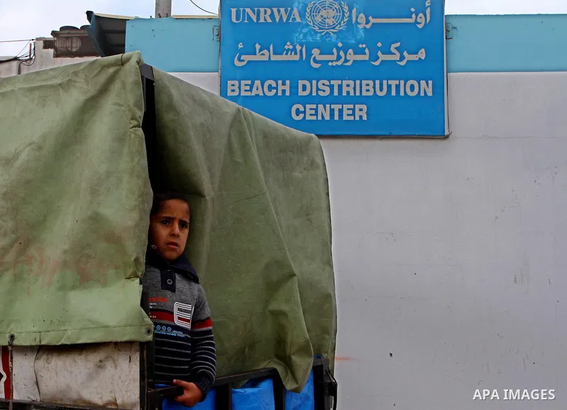 Palestinians receive their monthly food aid at a UN distribution center in the Shati refugee camp, in Gaza City, on January 17, 2012. The UN Agency for Palestinian Refugees (UNRWA) in Gaza launched an appeal for emergenc...