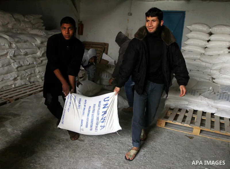 Palestinians receive their monthly food aid at a UN distribution center in the Shati refugee camp, in Gaza City, on January 17, 2012. The UN Agency for Palestinian Refugees (UNRWA) in Gaza launched an appeal for emergenc...