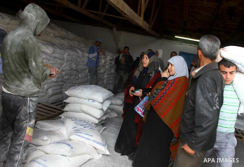 Palestinians receive their monthly food aid at a UN distribution center in the Shati refugee camp, in Gaza City, on January 17, 2012. The UN Agency for Palestinian Refugees (UNRWA) in Gaza launched an appeal for emergenc...