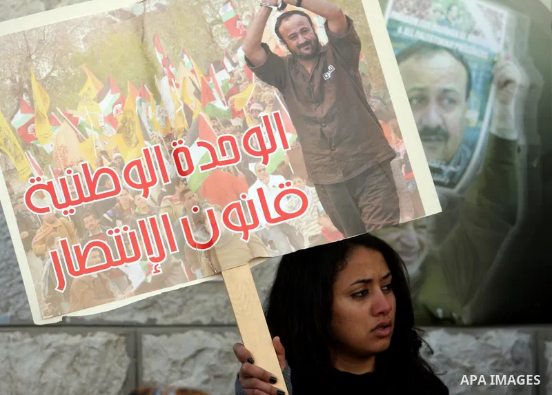 Palestinians hold portraits of relatives, held in Israeli jails, during a protest calling for their release, in the West Bank city of Ramallah, Tuesday, Jan. 17, 2012. Israel currently holds about 6,000 Palestinians in i...