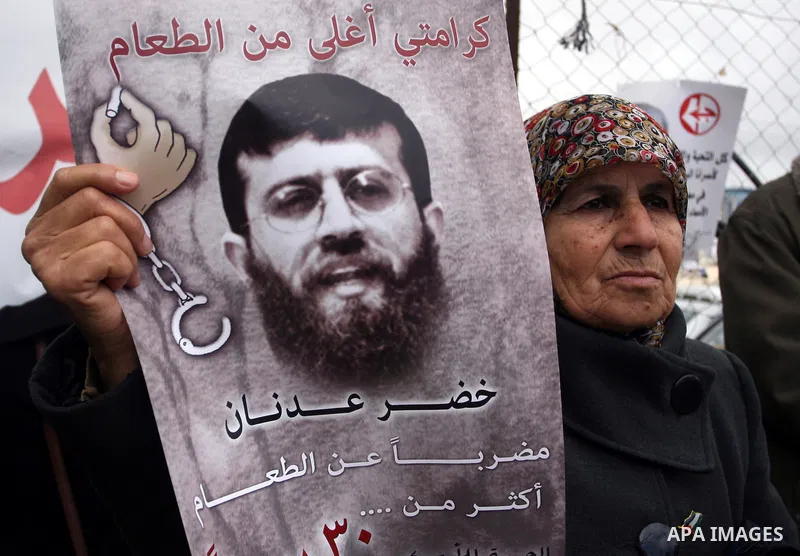 Palestinians hold portraits of relatives, held in Israeli jails, during a protest calling for their release, in the West Bank city of Ramallah, Tuesday, Jan. 17, 2012. Israel currently holds about 6,000 Palestinians in i...