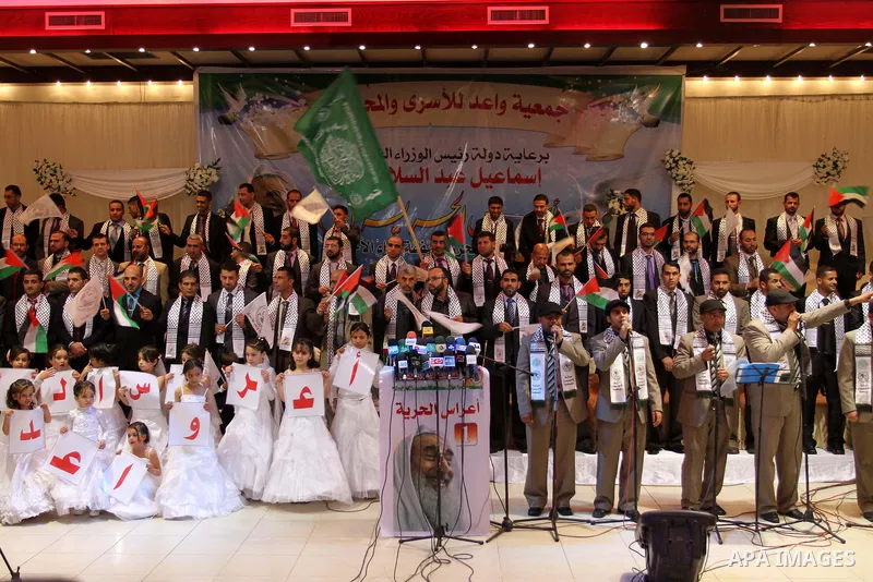 Palestinian bridegrooms attend a mass wedding organized by Waed Association for around 50 released Palestinian prisoners in Gaza city on January 17, 2012. Israel freed 550 Palestinian prisoners on December 19, 2011, comp...