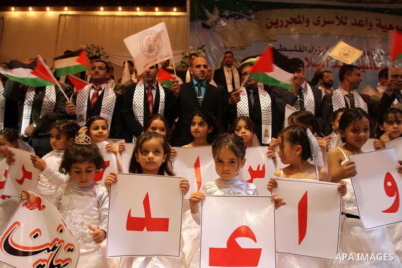 Palestinian bridegrooms attend a mass wedding organized by Waed Association for around 50 released Palestinian prisoners in Gaza city on January 17, 2012. Israel freed 550 Palestinian prisoners on December 19, 2011, comp...