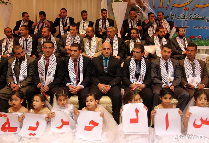 Palestinian bridegrooms attend a mass wedding organized by Waed Association for around 50 released Palestinian prisoners in Gaza city on January 17, 2012. Israel freed 550 Palestinian prisoners on December 19, 2011, comp...