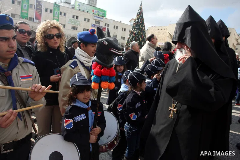 Christians celebrate during an Armenian Christmas procession through Manger Square to the Church of the Nativity in West Bank city of Bethlehem, Wednesday, Jan. 18, 2012. The Armenian Orthodox church in the Holy Land cel...