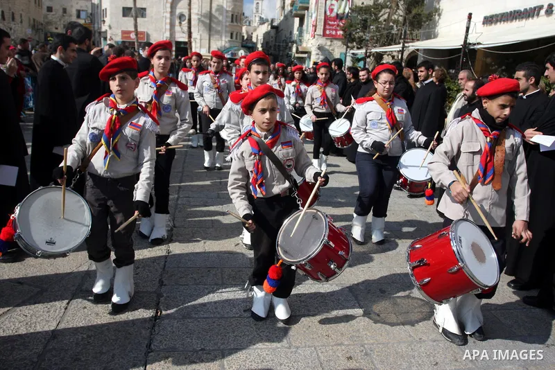 Christians celebrate during an Armenian Christmas procession through Manger Square to the Church of the Nativity in West Bank city of Bethlehem, Wednesday, Jan. 18, 2012. The Armenian Orthodox church in the Holy Land cel...