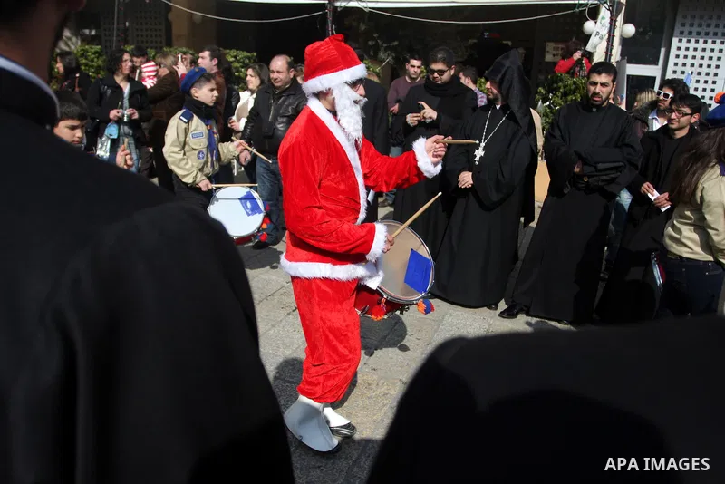 Christians celebrate during an Armenian Christmas procession through Manger Square to the Church of the Nativity in West Bank city of Bethlehem, Wednesday, Jan. 18, 2012. The Armenian Orthodox church in the Holy Land cel...