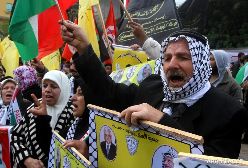Palestinians hold pictures of their prisoned relatives in Israeli jails as they gather in a protest calling for their liberty at the Red Cross headquarters in Gaza City on Jan. 19, 2012. Photo by Ashraf Amra