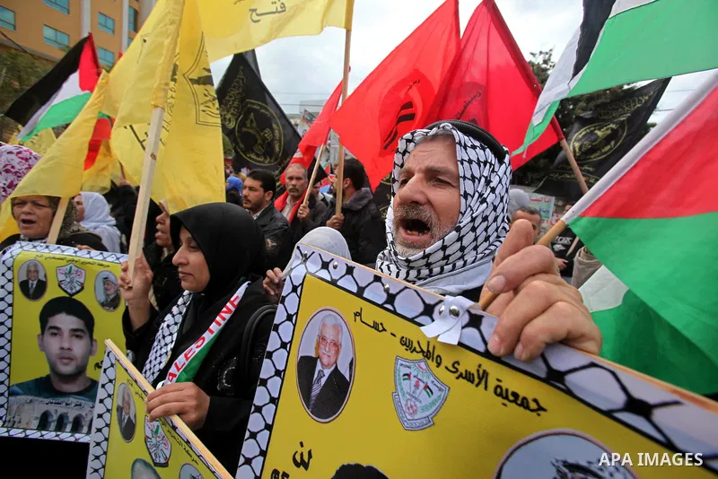 Palestinian women and children hold pictures of their prisoned relatives in Israeli jails as they gather in a protest calling for their liberty at the Red Cross headquarters in Gaza City on Jan. 19, 2012. Photo by Ashraf...