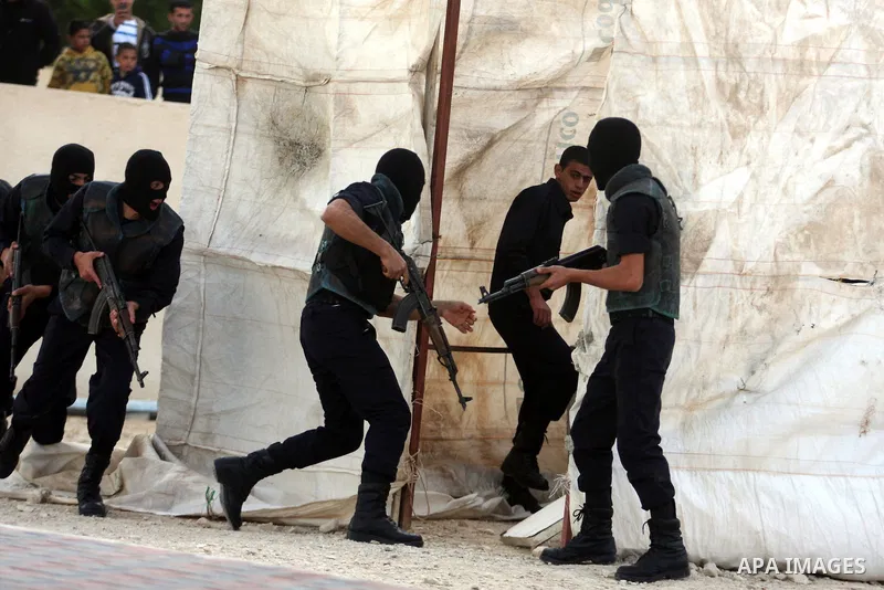 Palestinian security forces loyal to Palestinian President Mahmoud Abbas demonstrate their skills during a graduation ceremony in the West Bank city of Jericho, Thursday, Jan. 19, 2012. Photo by Issam Rimawi