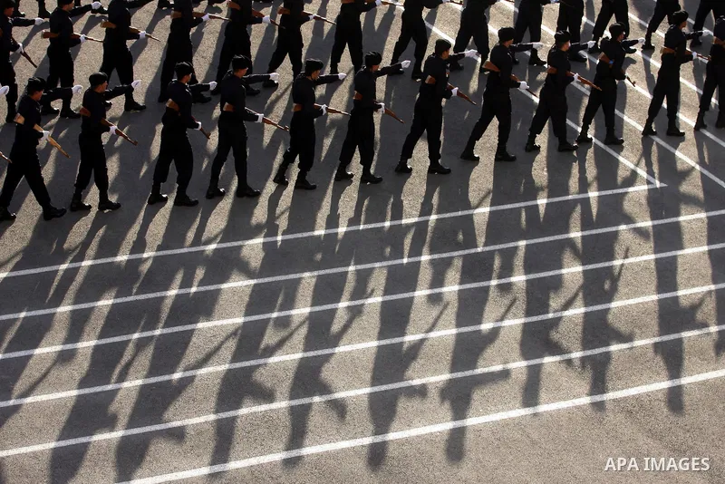 Palestinian security forces loyal to Palestinian President Mahmoud Abbas march with mock weapons during a graduation ceremony in the West Bank city of Jericho, Thursday, Jan. 19, 2012. Photo by Issam Rimawi