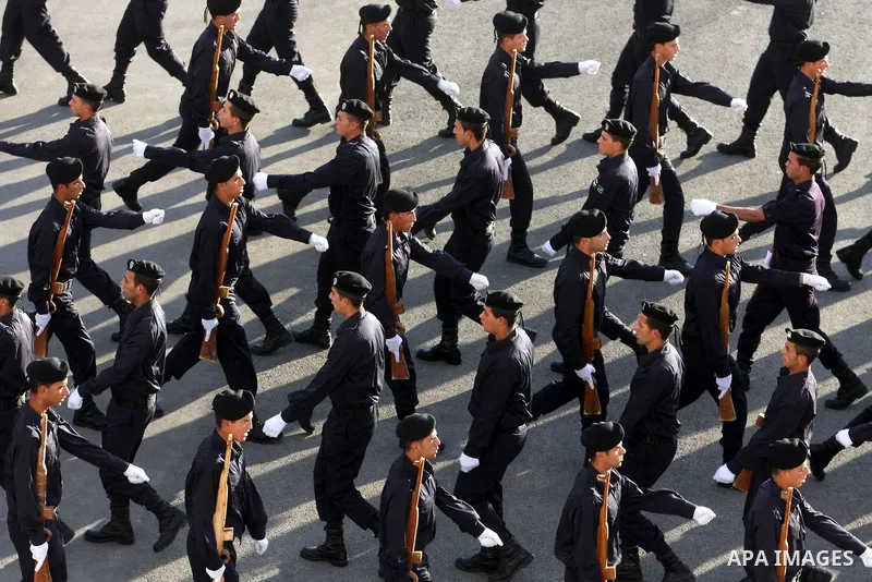 Palestinian security forces loyal to Palestinian President Mahmoud Abbas march with mock weapons during a graduation ceremony in the West Bank city of Jericho, Thursday, Jan. 19, 2012. Photo by Issam Rimawi