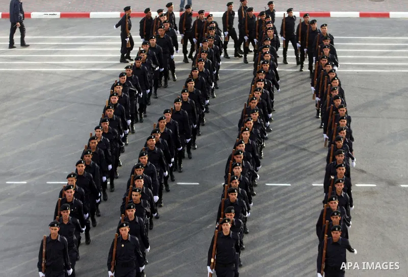 Palestinian security forces loyal to Palestinian President Mahmoud Abbas march with mock weapons during a graduation ceremony in the West Bank city of Jericho, Thursday, Jan. 19, 2012. Photo by Issam Rimawi