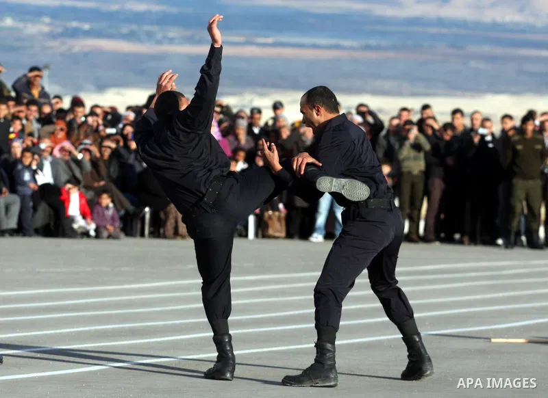 Palestinian security forces loyal to Palestinian President Mahmoud Abbas demonstrate their skills during a graduation ceremony in the West Bank city of Jericho, Thursday, Jan. 19, 2012. Photo by Issam Rimawi