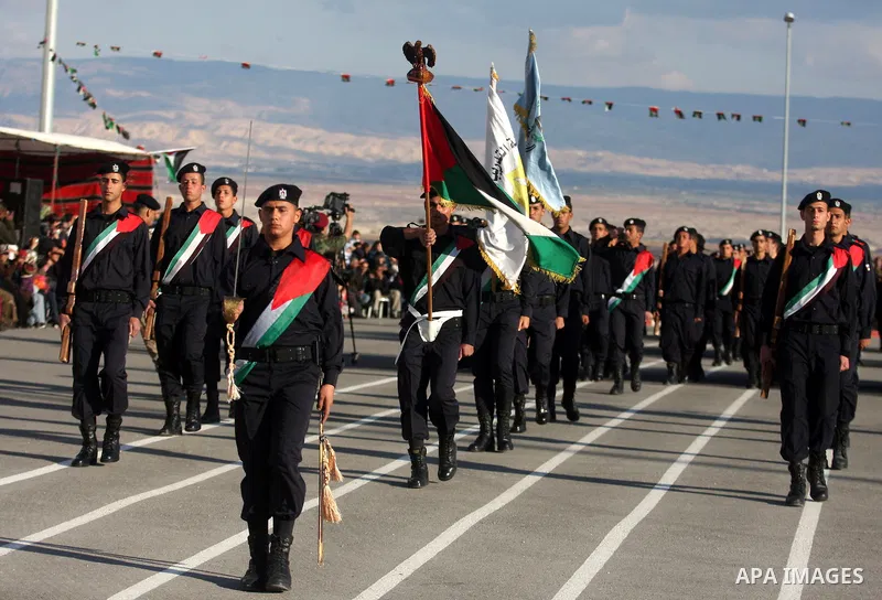 Palestinian security forces loyal to Palestinian President Mahmoud Abbas march with mock weapons during a graduation ceremony in the West Bank city of Jericho, Thursday, Jan. 19, 2012. Photo by Issam Rimawi