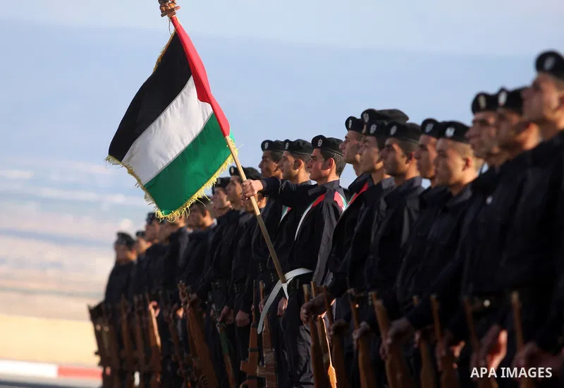 Palestinian security forces loyal to Palestinian President Mahmoud Abbas march with mock weapons during a graduation ceremony in the West Bank city of Jericho, Thursday, Jan. 19, 2012. Photo by Issam Rimawi