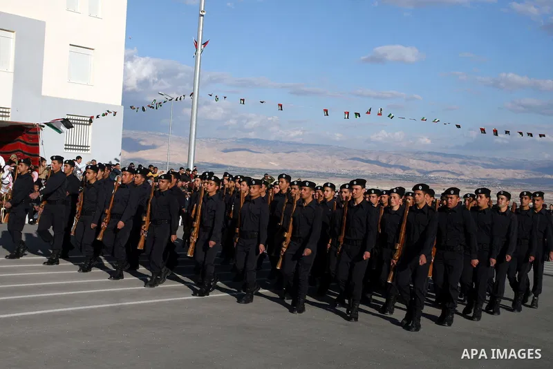 Palestinian security forces loyal to Palestinian President Mahmoud Abbas march with mock weapons during a graduation ceremony in the West Bank city of Jericho, Thursday, Jan. 19, 2012. Photo by Issam Rimawi