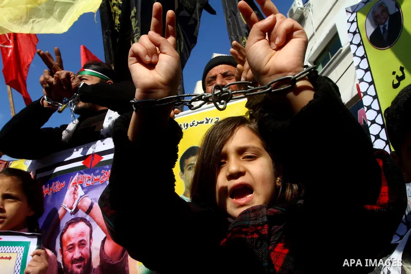 Families of Palestinian prisoners held in Israeli jails take part in a demonstration demanding their release, outside the Red Cross office in Gaza City, Jan. 21, 2012. Photo by Ashraf Amra