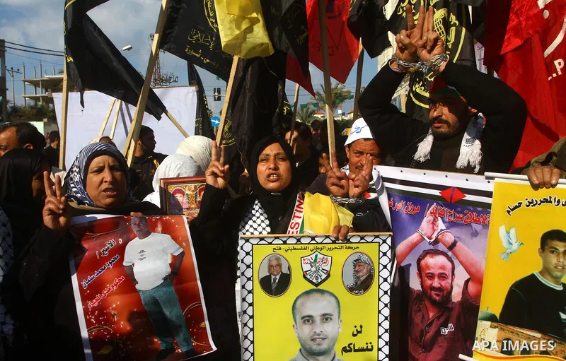 Families of Palestinian prisoners held in Israeli jails take part in a demonstration demanding their release, outside the Red Cross office in Gaza City, Jan. 21, 2012. Photo by Ashraf Amra