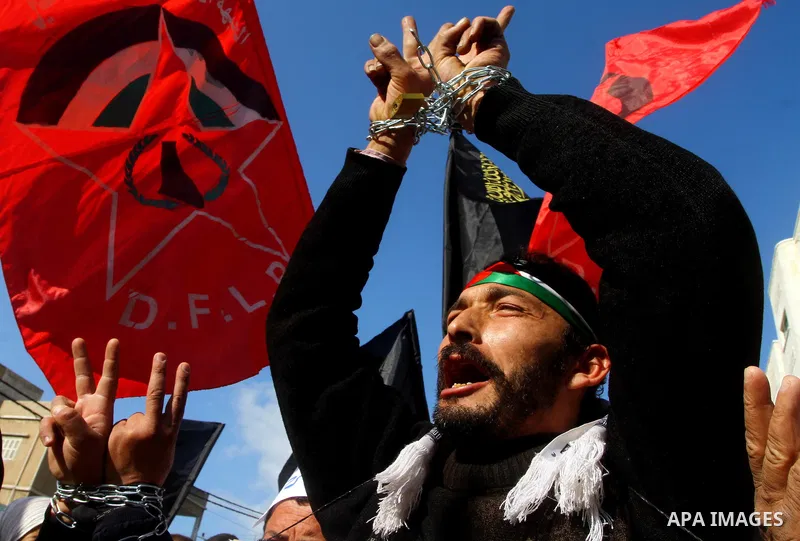 Families of Palestinian prisoners held in Israeli jails take part in a demonstration demanding their release, outside the Red Cross office in Gaza City, Jan. 21, 2012. Photo by Ashraf Amra
